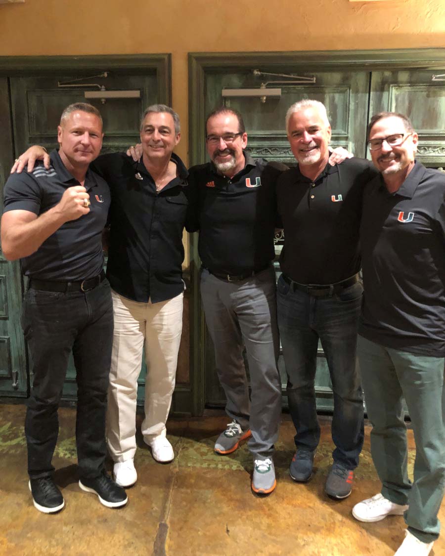 men posing in front door
